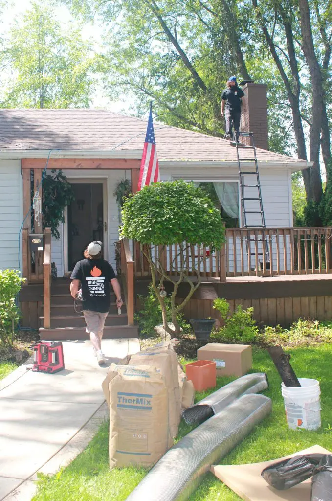 Chimney Workers Performing Service On A House